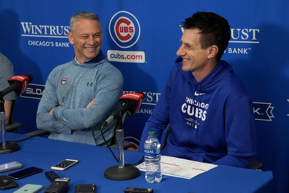 Chicago Cubs manager Craig Counsell, right, and president of baseball operations Jed Hoyer laugh during news conference prior to an MLB baseball spring training workout, Wednesday, Feb. 14, 2024, in Mesa, Ariz. (AP Photo/Matt York)