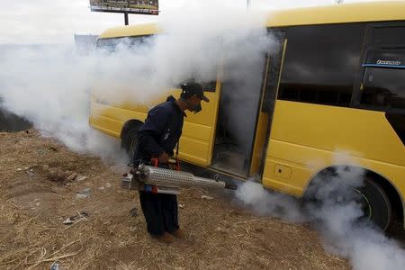 A municipal health worker fumigates a bus as part of the city's efforts to prevent the spread of the Zika virus vector, the Aedes aegypti mosquito, in Tegucigalpa, Honduras, January 30, 2016. REUTERS/Jorge Cabrera