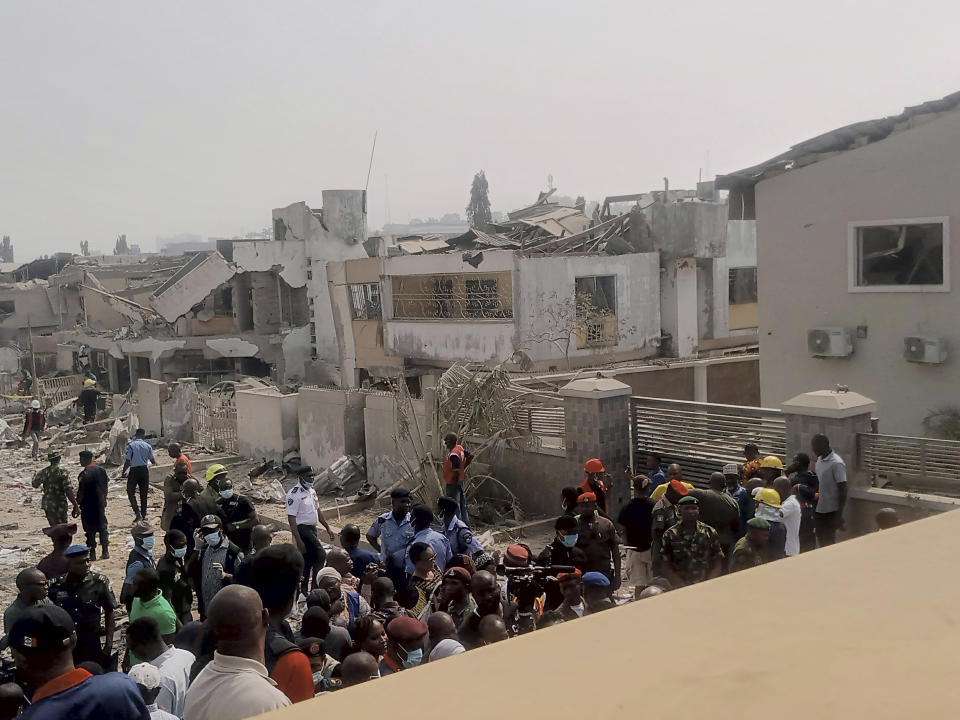 People gather at the site of an explosion in Ibadan, Nigeria, Wednesday, Jan. 17, 2024. Several people died and many others were injured after a massive blast caused by explosives rocked more than 20 buildings in one of Nigeria's largest cities Tuesday night, authorities said Wednesday, as rescue workers dug through the rubble in search of those feared trapped. (AP Photo)