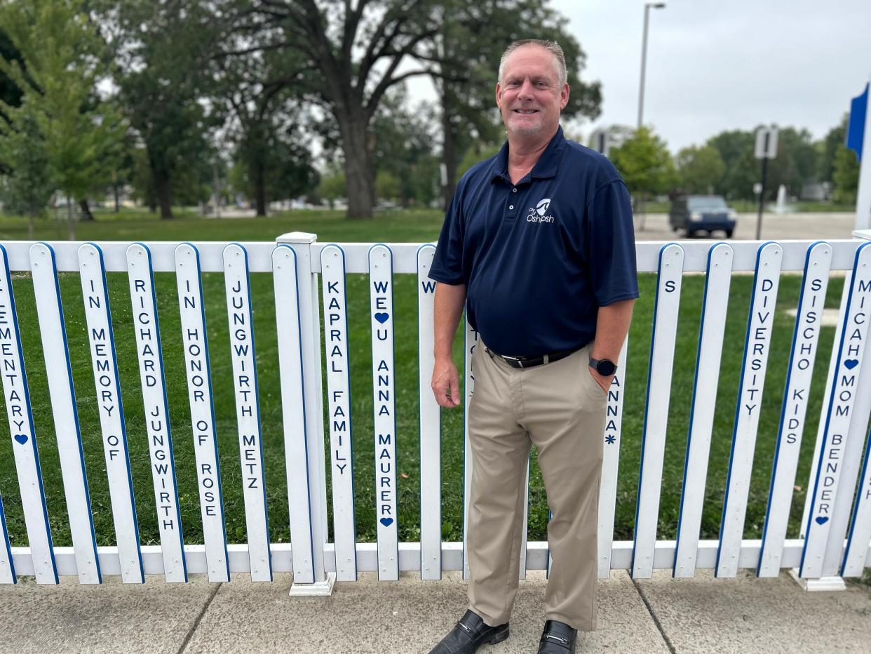 City of Oshkosh Parks Director Ray Maurer stands next to a fence picket for his daughter Anna Maurer at Oshkosh Inclusive Park, an inclusive playground at South Park. Anna, now 26, has cognitive and locomotive challenges. To this day, she still loves to swing at the playground.