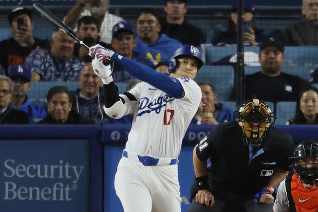 <p>Allen J. Schaben / Los Angeles Times via Getty Images</p> Dodgers designated hitter Shohei Ohtani, #17, hits his first home run as a Dodger off of Giants pitcher Taylor Rogers, # 33,