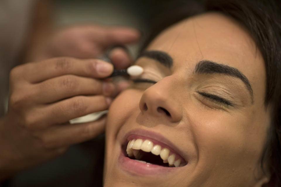 In this Dec. 4, 2012 photo, Brazilian transgender model Felipa Tavares has her makeup applied in preparation for a photo session in Rio de Janeiro, Brazil. The 6-foot-tall Tavares is among Brazil's small but growing ranks of transgender models _ leggy, high-cheekboned sirens who were born men and are causing a splash here as well as in Paris and other international fashion capitals. (AP Photo/Felipe Dana)