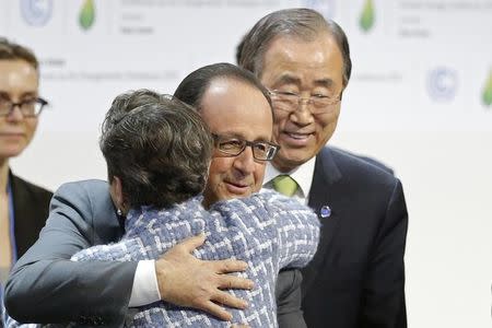 French President Francois Hollande (C) embraces Christiana Figueres, Executive Secretary of the UN Framework Convention on Climate Change, as United Nations Secretary-General Ban Ki-moon (R) looks on at the final plenary session at the World Climate Change Conference 2015 (COP21) at Le Bourget, near Paris, France, December 12, 2015. REUTERS/Stephane Mahe