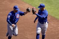 Chicago Cubs shortstop Eric Sogard, left, is congratulated by Cubs third baseman Ildemaro Vargas after Sogard's inning ending out against the Cleveland Indians during the second inning of a spring training baseball game Thursday, March 18, 2021, in Goodyear, Ariz. (AP Photo/Ross D. Franklin)