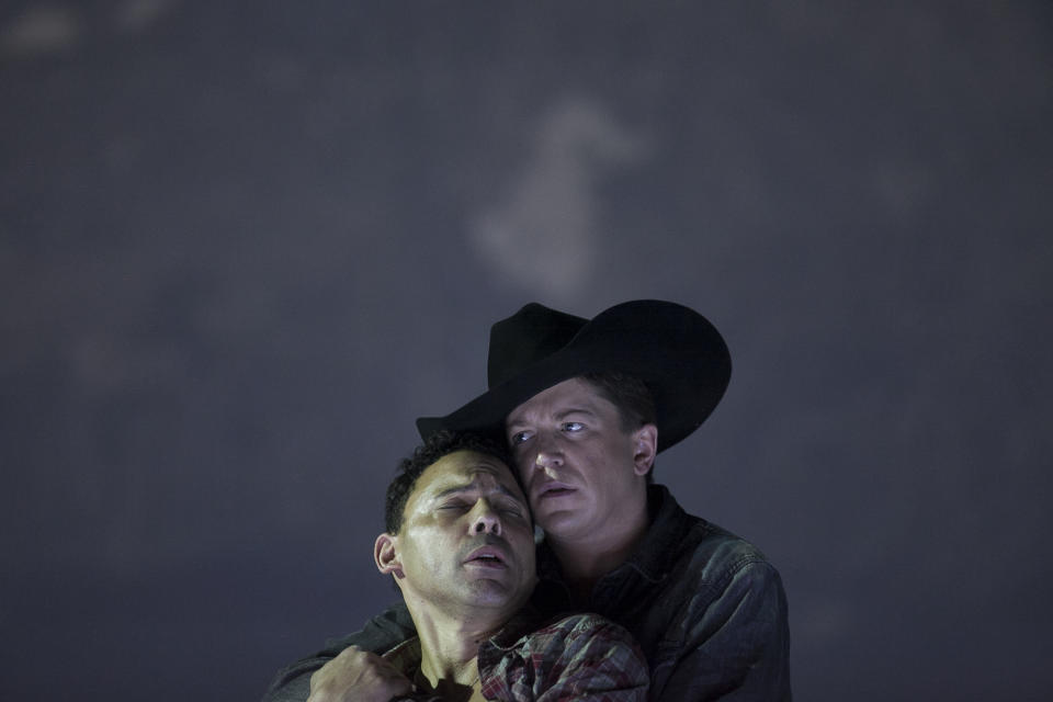 In this photo taken on Friday, Jan. 24, 2014, American tenor Tom Randle (Jack Twist), left, and Canadian bass-baritone Daniel Okulitch (Ennis del Mar), right, perform during the press rehearsal of the production "Brokeback Mountain" at the Teatro Real, in Madrid, Spain. It was a short story, then a Hollywood movie. Now the tragic tale of cowboys in love is being reinvented again: Brokeback Mountain _ the opera. Ahead of its world premiere in Madrid, author Annie Proulx told The Associated Press that the form of opera presented an opportunity to explore the complexities of the tale in a way neither her own short story nor the movie by director Ang Lee were able to do. (AP Photo/Gabriel Pecot)