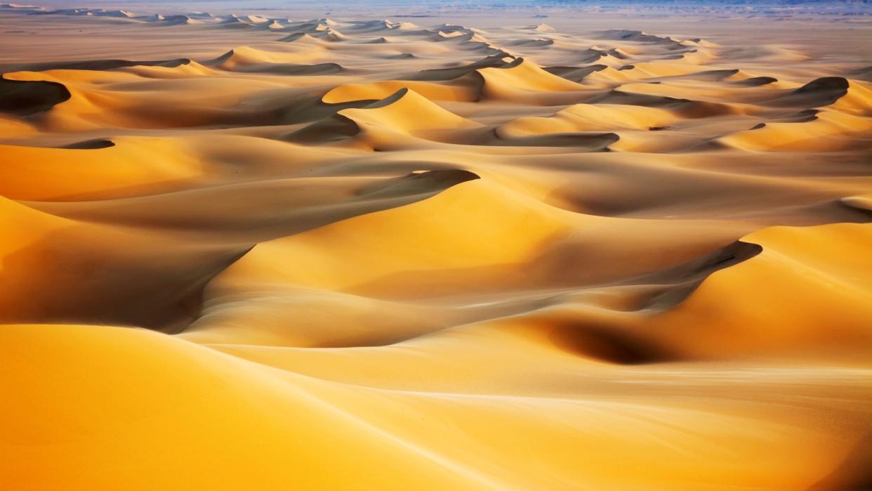  sunrise over sand dunes in the white desert in Egypt 
