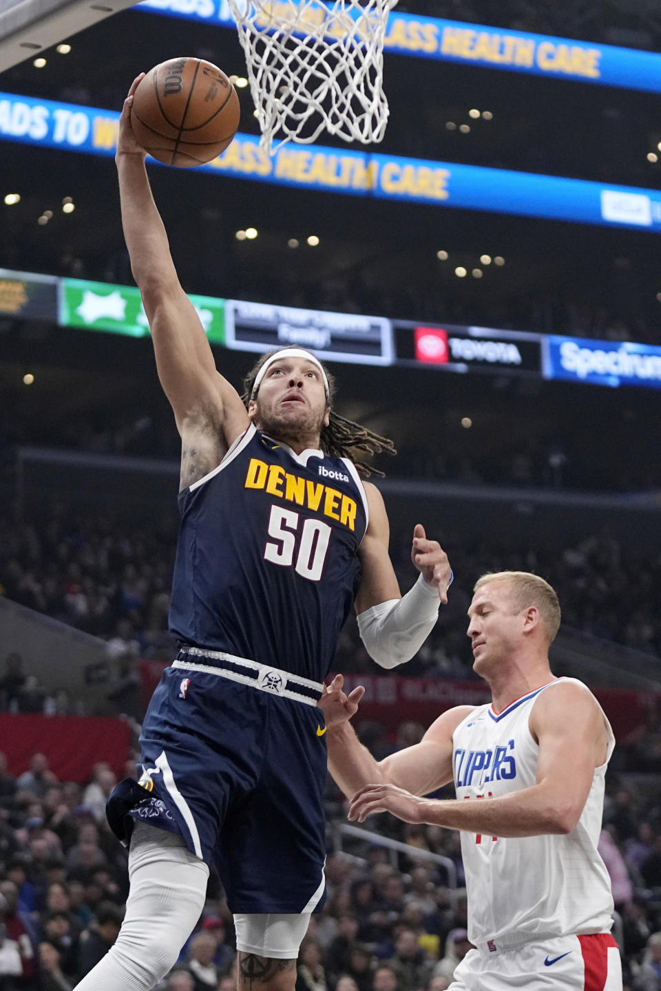 Denver Nuggets forward Aaron Gordon, left, shoots as Los Angeles Clippers center Mason Plumlee defends during the first half of an NBA basketball game Thursday, April 4, 2024, in Los Angeles. (AP Photo/Mark J. Terrill)