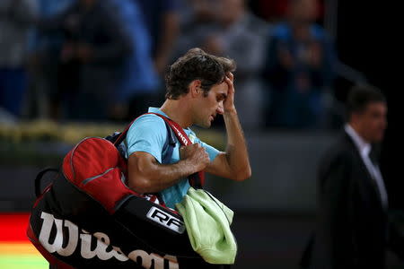 Roger Federer of Switzerland leaves the court after his defeat by Nick Kyrgios of Australia at the end of their match at the Madrid Open tennis tournament in Madrid, Spain, May 6, 2015. REUTERS/Susana Vera