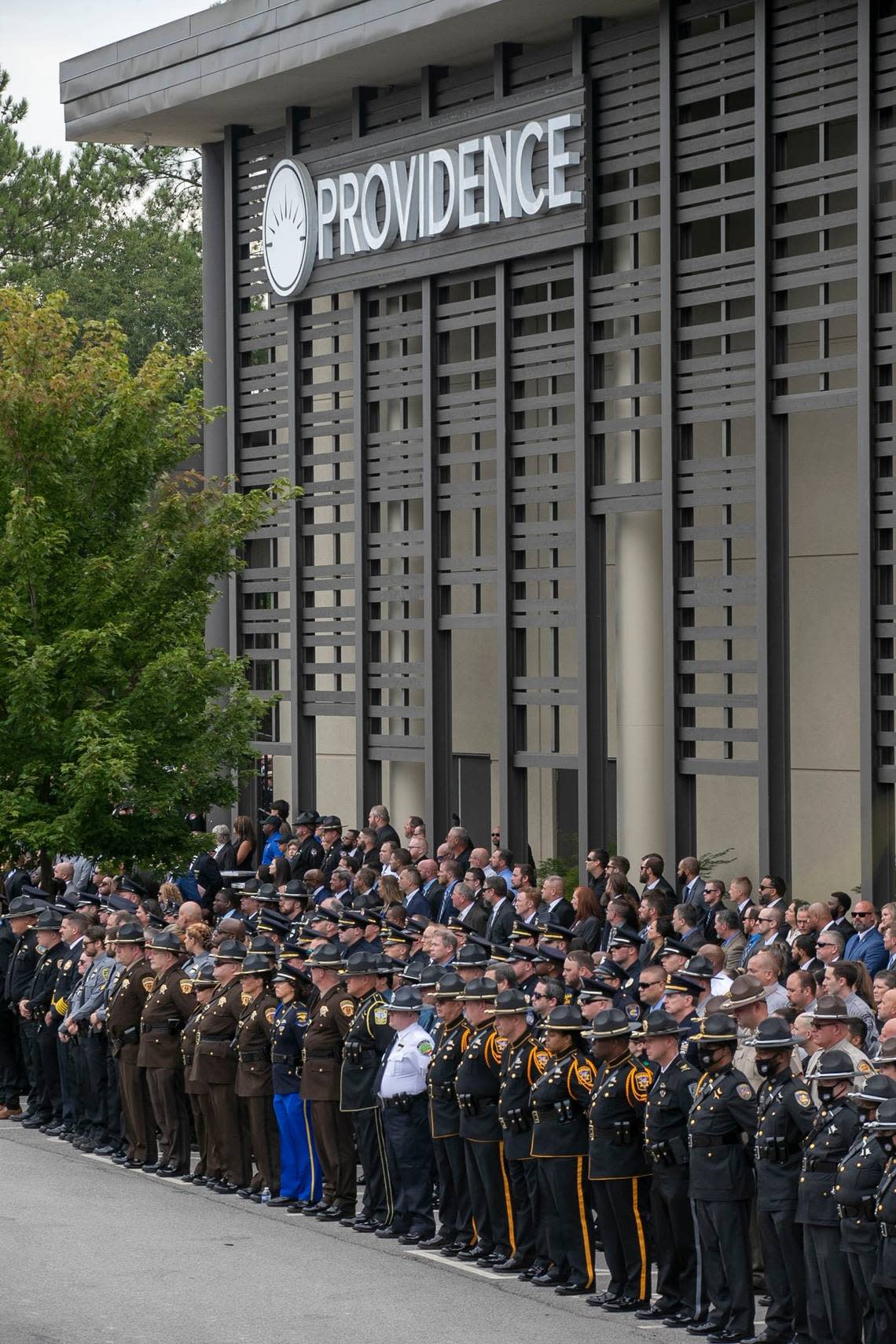 Law enforcement officers from across North Carolina stand at attention as Wake County Deputy Ned Byrds casket arrives for his funeral at Providence Baptist Church on Friday, August 19, 2022 in Raleigh, N.C.