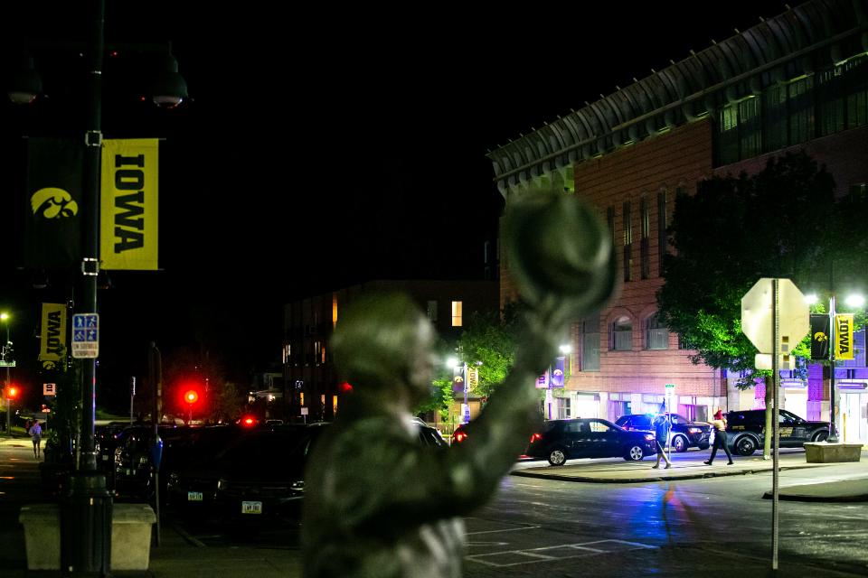 Iowa City Police officers investigate the scene of a shooting early Sunday, May 14, 2023, at the corner of Gilbert Street and Iowa Avenue in Iowa City, Iowa. The University of Iowa issued a HawkAlert just before midnight related to the incident.