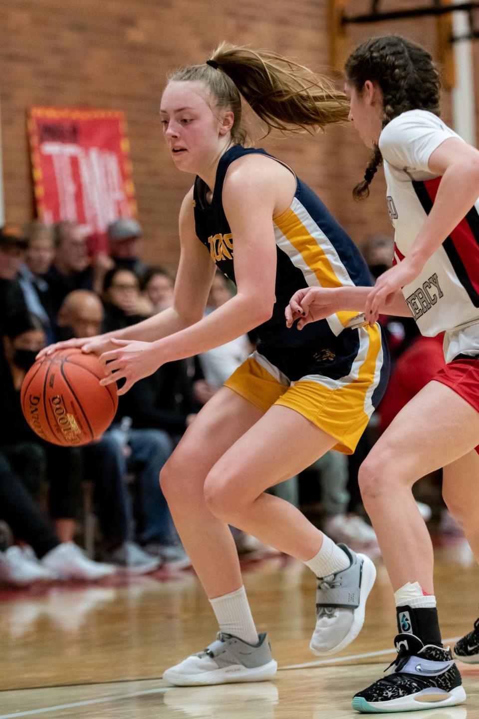 New Hope-Solebury's Reagan Chrencik dribbles while guarded by Gwynedd Mercy's Bianca Coleman in a District One Class 4A semifinal game, on Tuesday, February 22, 2022, at Gwynedd Mercy Academy High School in Lower Gwynedd. The Monarchs advance to the title game after defeating the Lions 56-28.