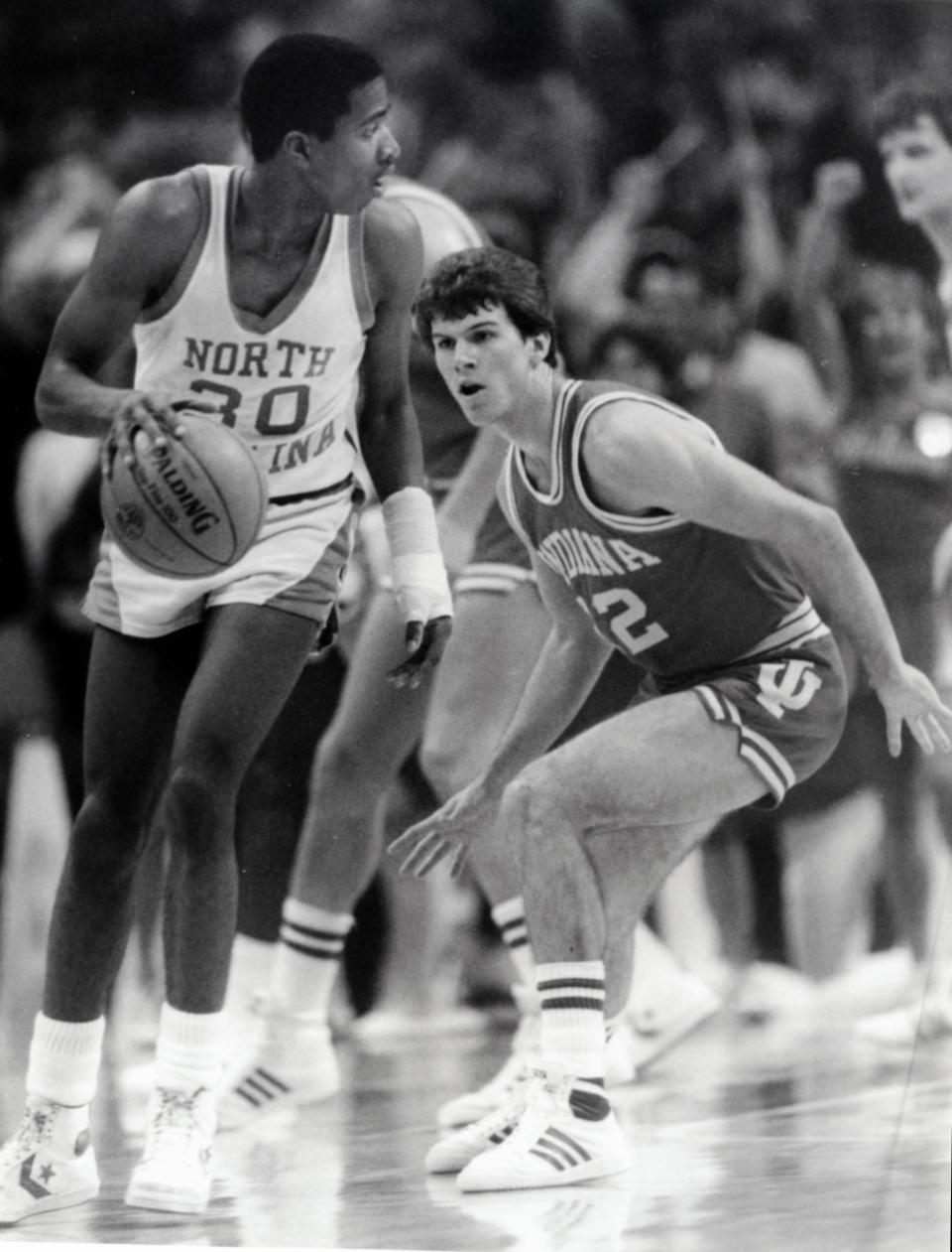 Indiana guard Steve Alford (12) in action against the North Carolina Tar Heels guard Kenny Smith (30) during the Sweet 16 for the NCAA basketball tournament. Indiana beat North Carolina 72-68. Malcolm Emmons-USA TODAY Sports