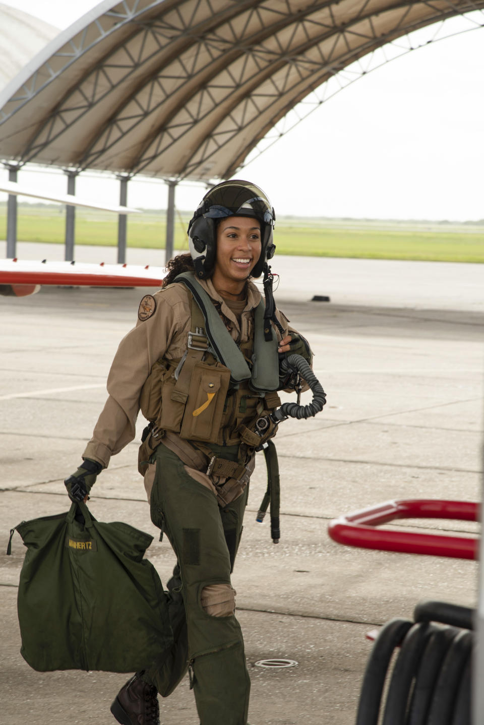 Student Naval Aviator Lt. j.g. Madeline Swegle, assigned to the Redhawks of Training Squadron (VT) 21 at Naval Air Station Kingsville, Texas, exits a T-45C Goshawk training aircraft following her final flight to complete the undergraduate Tactical Air (Strike) pilot training syllabus, July 7. Swegle is the U.S. Navy's first known Black female strike aviator and will receive her Wings of Gold during a ceremony July 31. | U.S. Navy photo by Anne Owens/Released