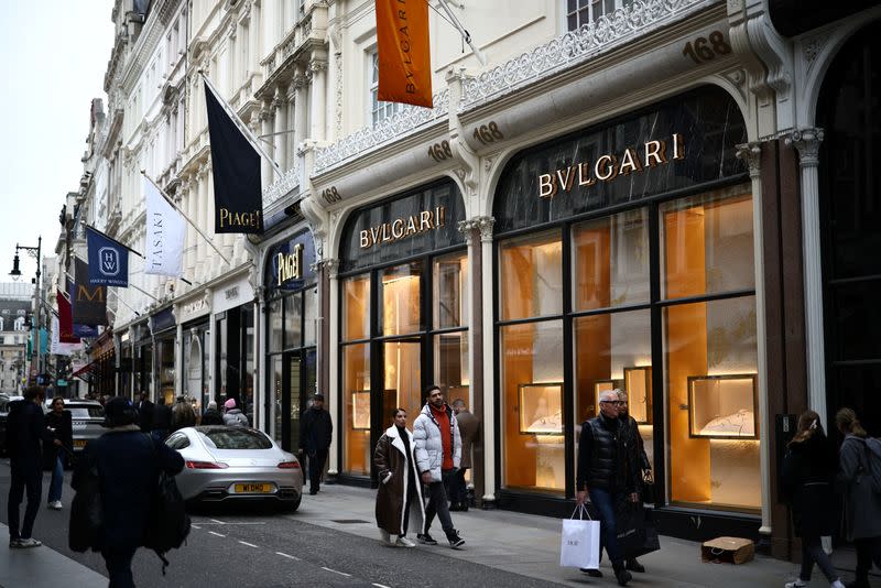 People walk outside a Bulgari store on New Bond Street in London
