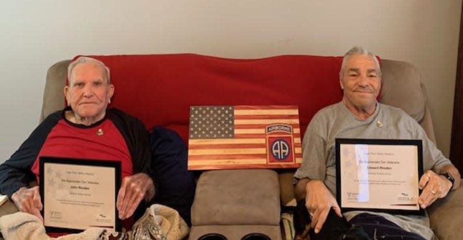 John Rhoden, left, and his son, Edward Rhoden. John served as a Sgt. Major in the Army, Edward as a specialist. Between them is a wooden flag designed by Southern Sons Design.