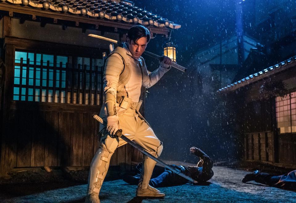 Andrew Koji wields twin swords as the ninja Storm Shadow in the "G.I. Joe Origins" action film "Snake Eyes."