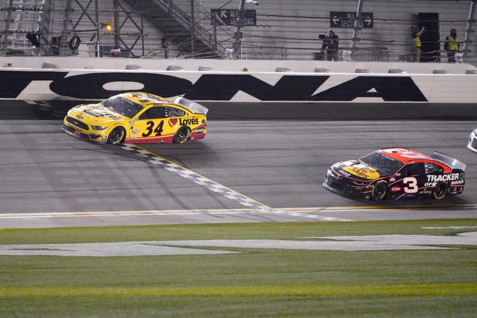 Michael McDowell cruza la línea de meta por delante de Austin Dillon para ganar la carrera Daytona 500 de la NASCAR en el Circuito Internacional de Daytona, el lunes 15 de febrero de 2021 en Daytona Beach, Florida. (AP Foto/John Raoux)