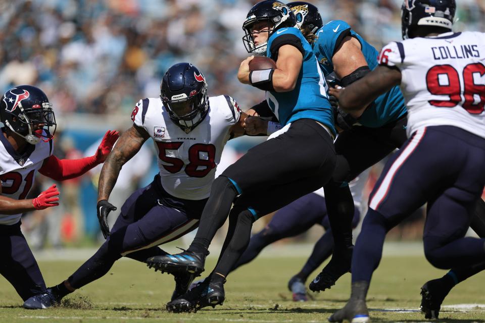 Jacksonville Jaguars quarterback Trevor Lawrence (16) is tackled by Houston Texans linebacker Christian Kirksey (58) during the second quarter of an NFL football game Sunday, Oct. 9, 2022 at TIAA Bank Field in Jacksonville. The Texans won 13-6. [Corey Perrine/Florida Times-Union]