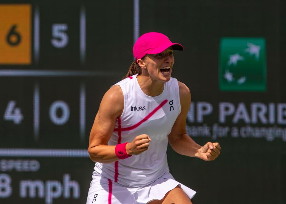 Iga Swiatek celebrates winning the match and championship point over Maria Sakkari to end the WTA final of the BNP Paribas Open in Indian Wells, Calif., Sunday, March 17, 2024.