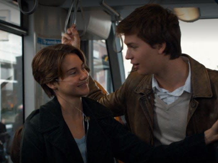 Hazel and Augustus in a streetcar.