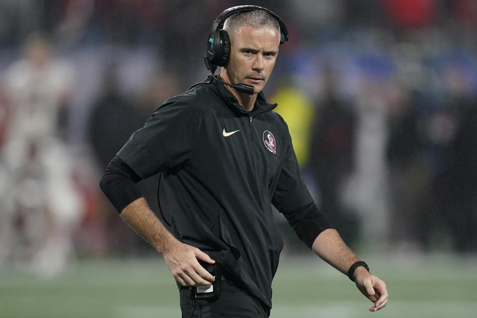 FILE - Florida State coach Mike Norvell walks on the field during a timeout in the second half of the team's Atlantic Coast Conference championship NCAA college football game against Louisville, Dec. 2, 2023, in Charlotte, N.C. Unbeaten Florida State was snubbed by the College Football Playoff last season. Norvell echoed the sentiment of other coaches, saying the ACC needs to fight its perception problem. “(We) have to continue to push the actual narrative or what needs to be the realistic narrative of how good this this league is,” he said. (AP Photo/Erik Verduzco, File)