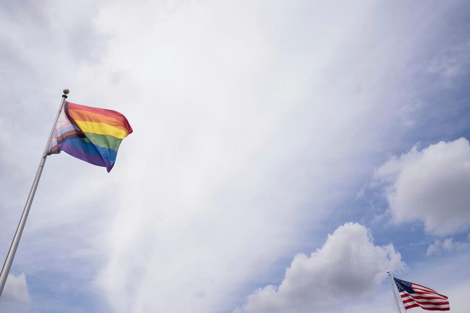 An LGBTQ pride flag waves alongside a U.S. flag on Jos Campau in Hamtramck on Sunday, July 9, 2023. 