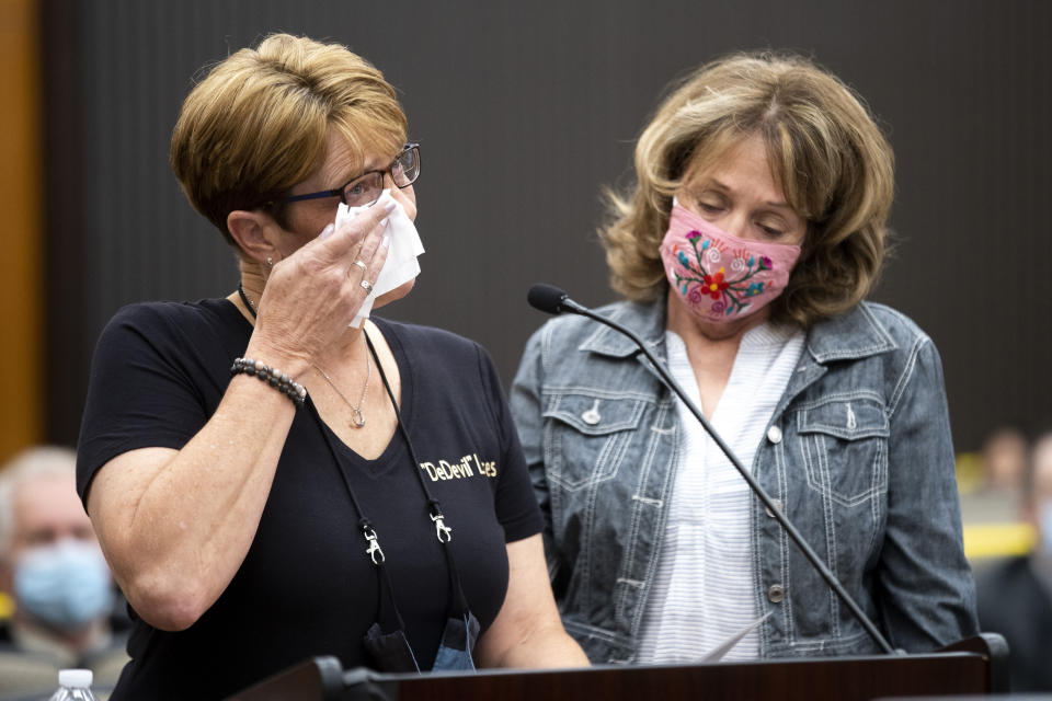 Debbi McMullan, left, and Melanie Barbeau confront Joseph James DeAngelo at the Sacramento County Courthouse during the third day of victim impact statements on Thursday, Aug. 20, 2020, in Sacramento, Calif. DeAngelo, a former California police officer, has admitted to being the infamous Golden State Killer, committing 13 murders and nearly 50 rapes between 1975 and 1986. DeAngelo killed McMullan's mother, Cheri Domingo, and Domingo's boyfriend, Gregory Sanchez. (Santiago Mejia/San Francisco Chronicle via AP, Pool)