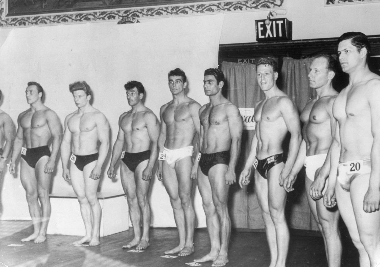 Sean Connery, at center, poses during a bodybuilding competition.