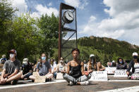 Jenelle Figgins, center, leads a moment of silent meditation before protesters march through the streets of Aspen, Colo., Sunday, May 31, 2020, to demonstrate against the death of George Floyd. Protests were held throughout the country over the death of Floyd, a black man who died after being restrained by Minneapolis police officers on May 25. (Kelsey Brunner/The Aspen Times via AP)