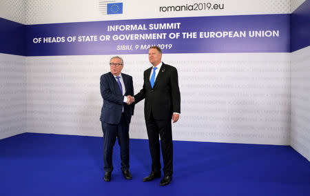 European Commission President Jean-Claude Juncker is welcomed by Romanian President Klaus Iohannis as he arrives for the informal meeting of European Union leaders in Sibiu, Romania, May 9, 2019. REUTERS/Stoyan Nenov