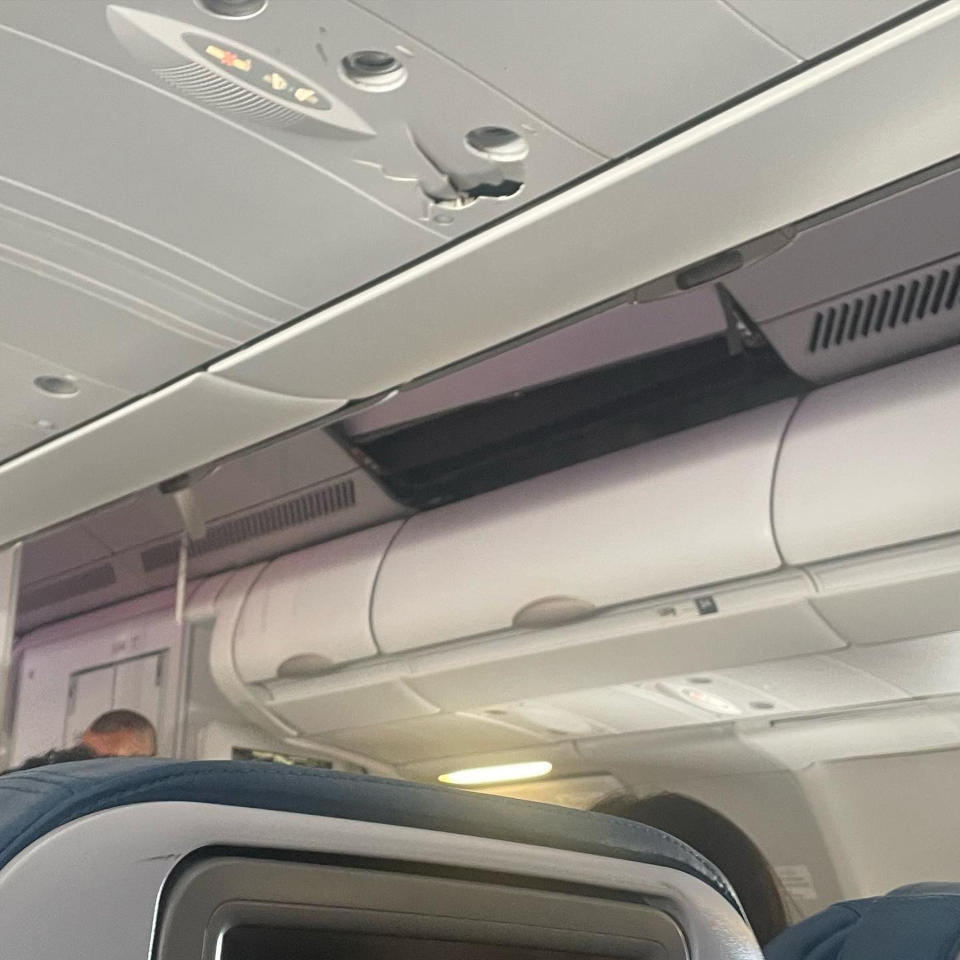 This mobile photo courtesy of passenger Jazmin Bitanga shows the interior of a Hawaiian Airlines plane on its flight from Phoenix to Honolulu, Sunday, Dec. 18, 2022, after severe turbulence rocked the flight. (Courtesy of Jazmin Bitanga via AP)