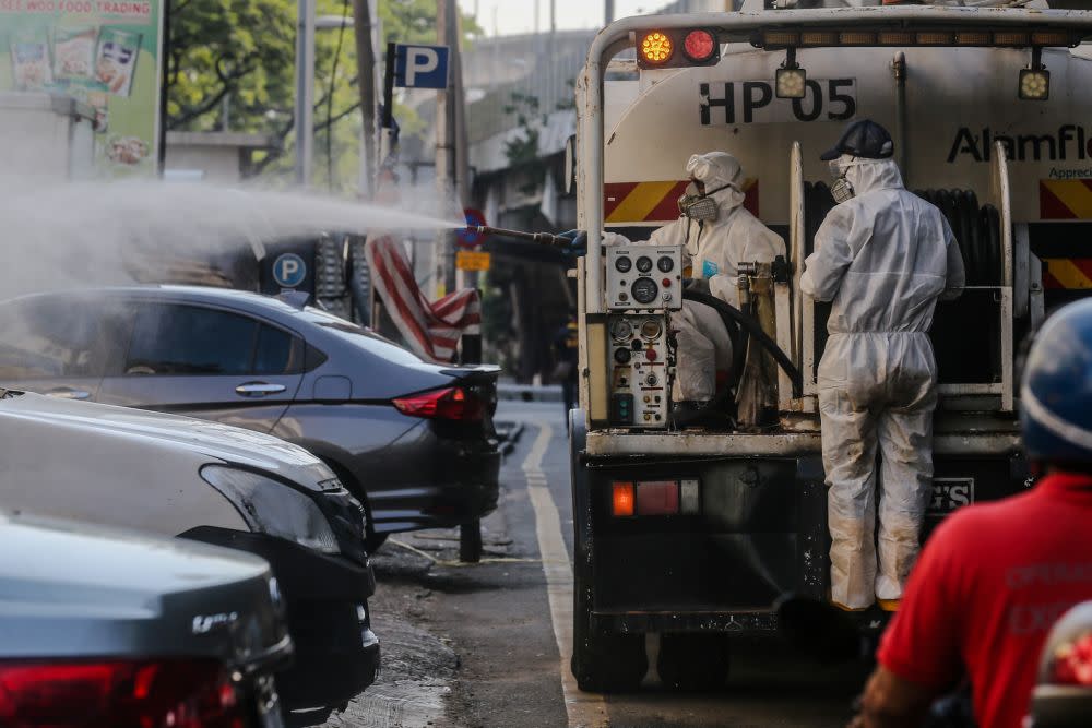 An Alam Flora personnel sprays disinfectant at Pasar Pudu to prevent the spread of the coronavirus in Kuala Lumpur April 1, 2020. — Picture by Firdaus Latif