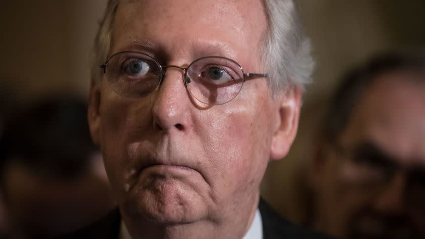 Senate Majority Leader Mitch McConnell, R-Ky., listens to remarks by Sen. Lindsey Graham, R-S.C., during a news conference as they faced assured defeat on the Graham-Cassidy bill, the GOP's latest attempt to repeal the Obama health care law, at the Capitol in Washington, Tuesday, Sept. 26, 2017. The decision marked the latest defeat on the issue for President Donald Trump and Senate Majority Leader Mitch McConnell in the Republican-controlled Congress. (AP Photo/J. Scott Applewhite)