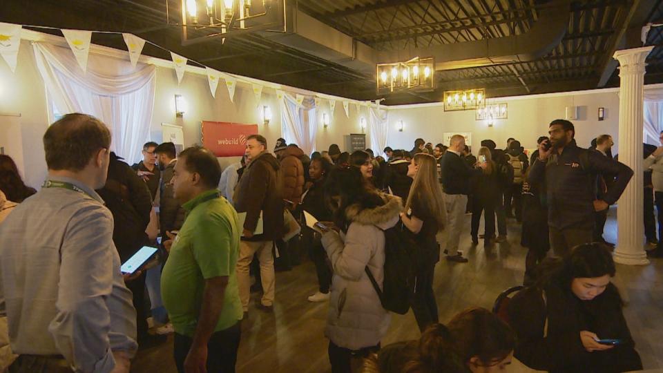 People gather at the Metrolinx job fair held in Thorncliffe Park on Jan. 24. The Toronto Community Benefits Network says they have concerns about Metrolinx's hiring targets for underserved groups and neighbourhoods like Thorncliffe Park that are impacted by the Ontario Line.  (Vedran Lesic/CBC - image credit)