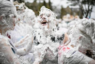 <p>Students from St Andrews University indulge in a tradition of covering themselves with foam to honor the “academic family” on Lower College Lawn on Oct. 23, 2017, in St Andrews, Scotland. (Photo: Jeff J Mitchell/Getty Images) </p>