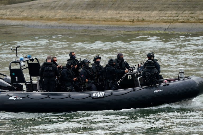 Una lancha con personal de seguridad navega el río Sena