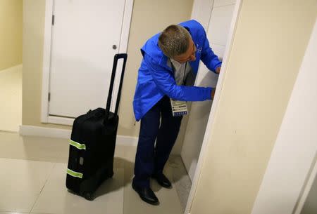 International Olympic Committee (IOC) President Thomas Bach struggles with the door before requesting another key as he moves into the Olympic village in Rio de Janeiro, Brazil, July 28, 2016. REUTERS/Ivan Alvarado