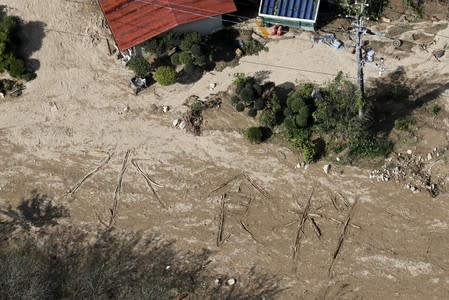 An aerial view shows the characters for "water and food" written on muddy ground at a flooded area caused by Typhoon Hagibis in Marumori Town