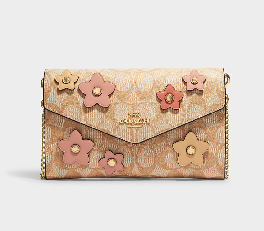 Envelope Clutch Crossbody In Signature Canvas With Floral Applique. Image via Coach Outlet.