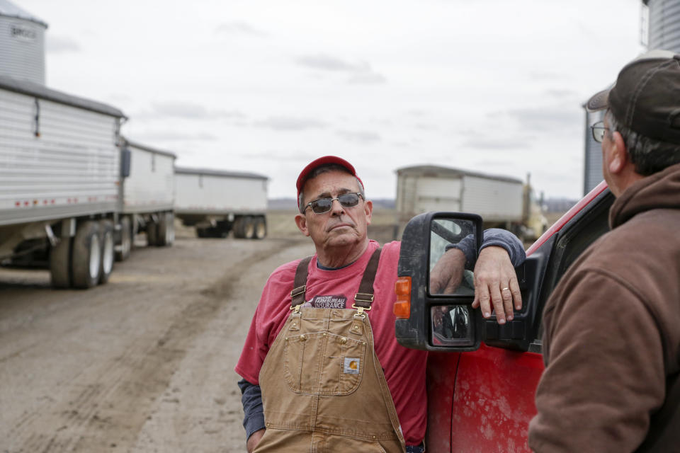 In this Tuesday, April 4, 2017, photo, Blake Hurst, a corn and soybean farmer and president of the Missouri Farm Bureau, left, talks with his brother Kevin Hurst on his farm in Westboro, Mo. U.S. President Donald Trump has vowed to redo the North American Free Trade Agreement, but NAFTA has widened access to Mexican and Canadian markets, boosting U.S. farm exports and benefiting many farmers. Hurst says NAFTA has been good for his business and worries that he'll lose out in a renegotiation. (AP Photo/Nati Harnik)