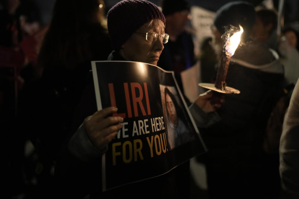 A woman holds a torch during a march demanding the immediate release of the Israeli hostages held in the Gaza Strip by the Hamas militant group, in Jerusalem, Monday, Feb. 19, 2024. (AP Photo/Leo Correa)