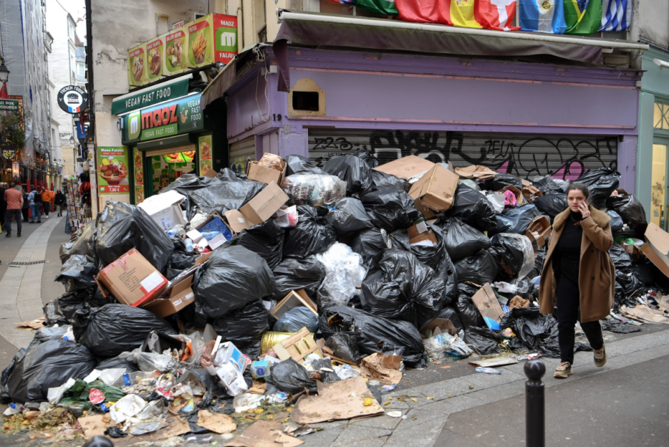 a huge pile of garbage bags in the streets of france