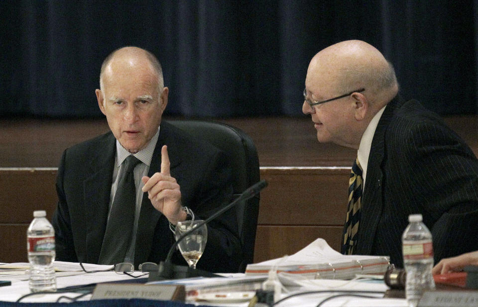 Gov. Jerry Brown, left, talks with University of California President Mark Yudof at the UC Board of Regents meeting in San Francisco, Wednesday, Nov. 14, 2012. (AP Photo/Jeff Chiu)