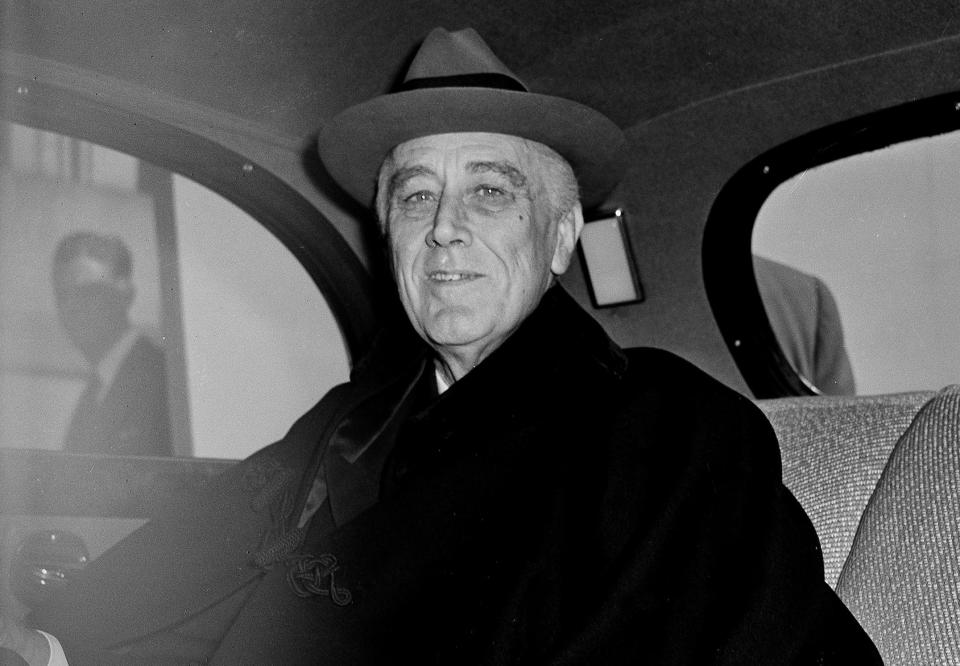 President Franklin D. Roosevelt smiles as he arrives at the Capitol in Washington, D.C., to report to Congress on his conferences at Malta and Yalta in the Crimea, March 1, 1945. He died just over a month later, on April 12.