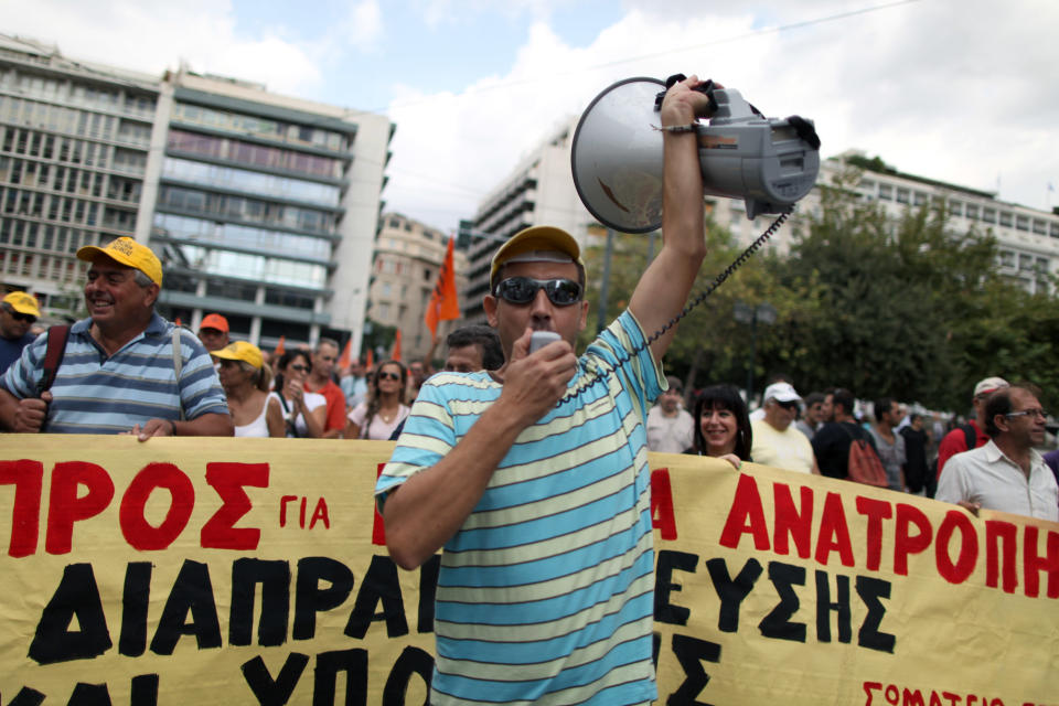 Greek municipal workers protest against the new austerity measures outside the Ministry of Finance, in central Athens, on Wednesday, Sept. 12, 2012. A fresh wave of anti-austerity strikes hit Greece Wednesday as the leaders of the governing coalition struggled to finalize further spending cuts for the coming two years — without which the country will lose its vital rescue loans.(AP Photo/Petros Giannakouris)