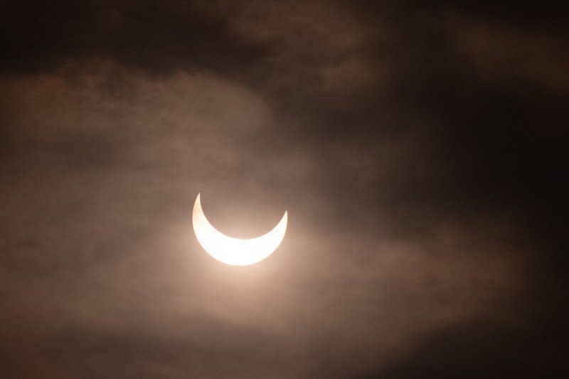 The Moon begins to cover the Sun for an annular eclipse in Winnemucca, Nevada, on Saturday. Heavy cloud cover limited the visibility of the event. Photo by Terry Schmitt/UPI