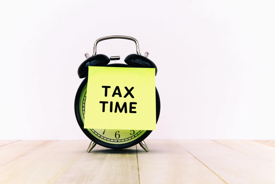 Tax Time Text on Adhesive Note on Alarm Clock. Source: Getty Images