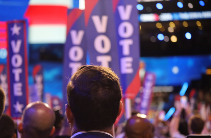 Delegate at the Democratic National Convention watches former President Barack Obama give a speech in Chicago on Aug. 21, 2024. (Photo by Shaun Griswold / Source NM)