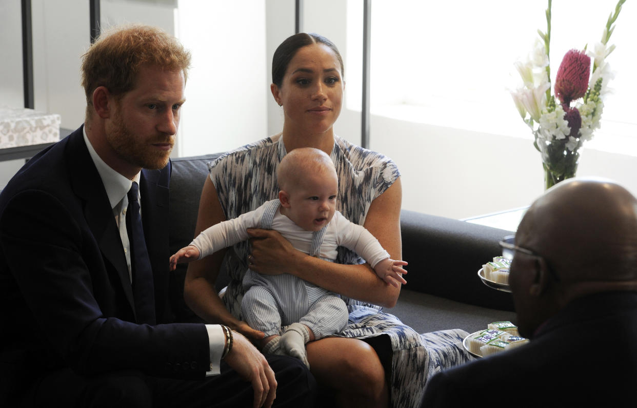 Britain's Prince Harry and Meghan, Duchess of Sussex, holding their son Archie, meet with Anglican Archbishop Emeritus, Desmond Tutu in Cape Town, South Africa, Wednesday Sept. 25, 2019. The royal couple are on the third day of their African tour. (Henk Kruger/African News Agency via AP, Pool)