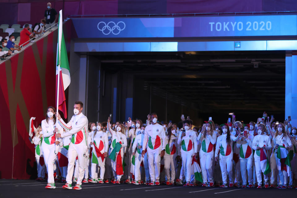 <p>TOKYO, JAPAN - JULY 23: Flag bearers Jessica Rossi and Elia Viviani of Team Italy lead their team out during the Opening Ceremony of the Tokyo 2020 Olympic Games at Olympic Stadium on July 23, 2021 in Tokyo, Japan. (Photo by Jamie Squire/Getty Images)</p> 